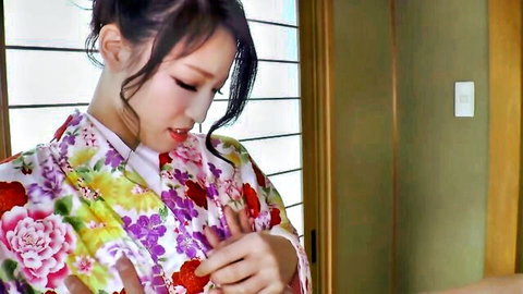 Seductive Asian brunette in floral kimono teasing with hand on chest and sultry gaze