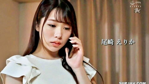Japanese woman in white ruffled blouse talking on phone