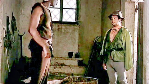 Sexy Robin Hood parody: muscular hunk and green-clad thief in medieval costumes