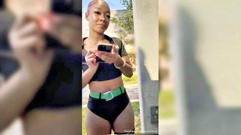 Curvy ebony woman in black bikini top and bottoms posing outdoors, Shake Shack