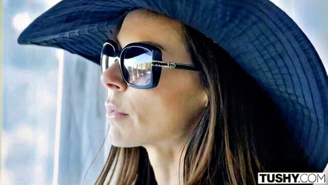 Kendra Lust seductive profile in blue hat and sunglasses