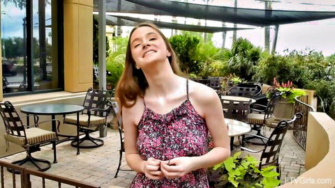 Hazel Moore smiling in floral summer dress outdoors, cute solo tease