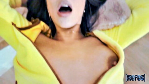 Tru Kait topless in open yellow hoodie, exposing big tits, mouth open in pleasure