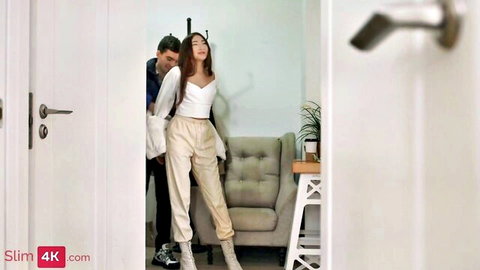 Exotic slim girl in tight pants warmed up by guy behind her, intimate pose