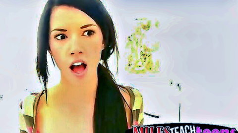 Asian brunette teen opens mouth wide with surprised expression and cleavage in yellow top