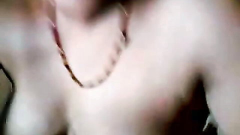 Blurry closeup of sexy Indian mature woman's deep cleavage with beaded necklace