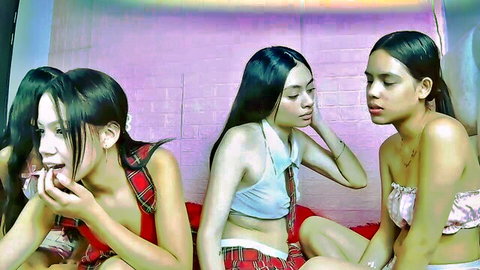 Three sexy Asian schoolgirls in plaid uniforms posing seductively on webcam