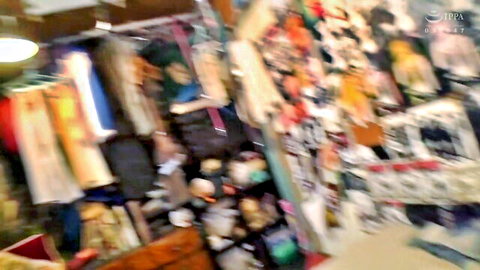 Blurry view of colorful hanging clothes in a shop interior