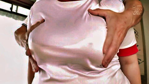 Busty Japanese woman in shiny white top gets huge tits groped from behind by man.