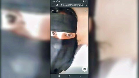 Mysterious Arab Tango model in black niqab, teasing eyes visible in premium show