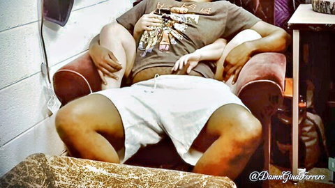 Black man lounging in t-shirt and shorts, relaxed pose