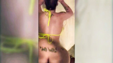 Curvy Latina teases with big tattooed ass in yellow bikini bottom