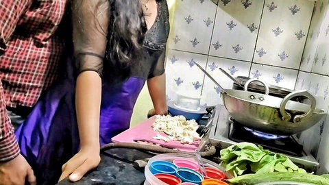 Indian step sister Ashu in sheer black top and purple skirt cooking in kitchen