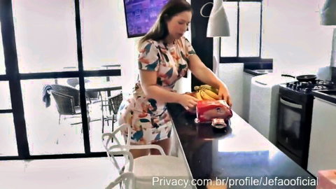 Francis Simas in floral dress teasing with banana