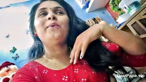 Sexy Indian Mallu teacher in red blouse showing cleavage, smiling seductively