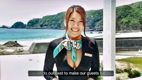 Japanese flight attendant in low-cut uniform smiles at beach resort