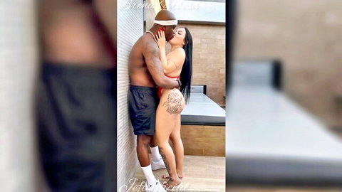 Brena Barbosa in red bikini kissing muscular black man outdoors