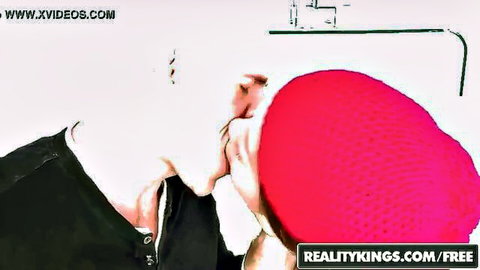 Brunette in sexy red beanie hat passionately kissed on neck by guy in black shirt
