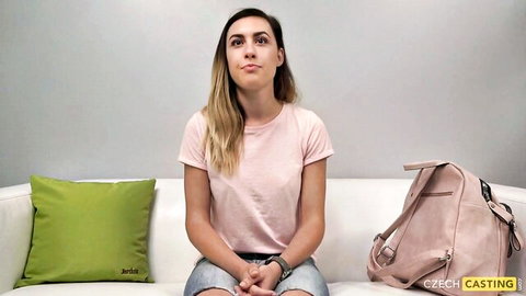 Czech casting Jirina in pink top, thoughtful pose on couch