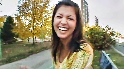 Smiling amateur Asian teen Lucy in yellow top outdoors in forest