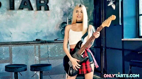 Blonde Luna Bunny poses sexy with guitar in crop top and plaid skirt