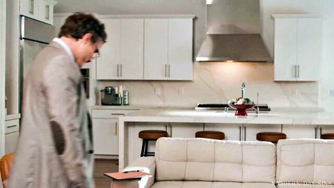 Lauren Phillips in teasing kitchen scene with suited man