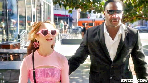 Isabella Nice in revealing pink top with black stud outdoors