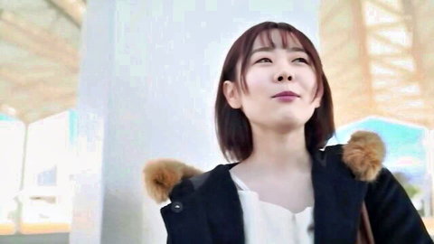 Sakura Miura in black fur-trimmed coat, shy smile outdoors