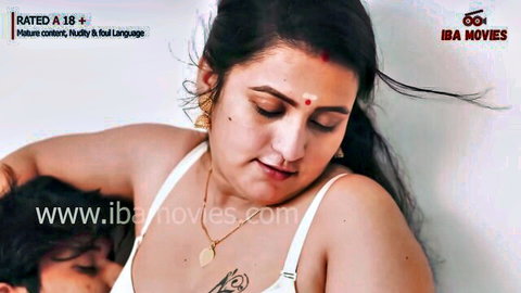 Sexy Indian MILF in low-cut white blouse with deep cleavage as dark lover nuzzles her tits close-up