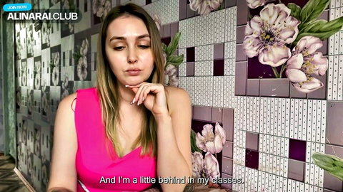 Alina Rai, busty Russian MILF in pink top, teasing behind glasses
