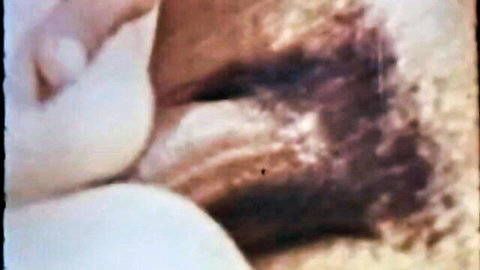 Closeup of massive pale white tits with pink nipples in grainy retro porn