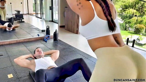 Bubble butt fit babe in tight shorts stands over muscular guy hip thrusting in gym