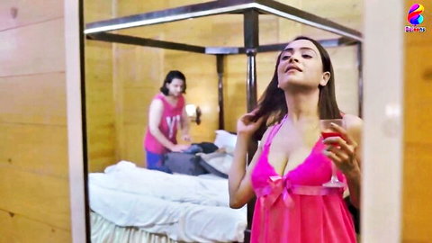 Sensual Indian MILF in revealing pink babydoll lingerie flaunts big tits and cleavage in bedroom mirror