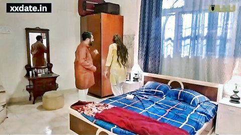 Desi Indian couple in traditional attire flirting in bedroom