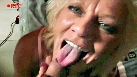 Blonde milf teases with tongue out in close-up seductive shot