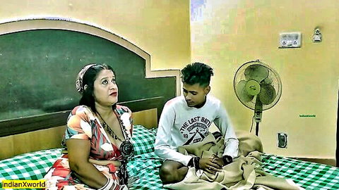 Desi tribal girl in colorful wrap dress seduces young Indian teen boy on bed