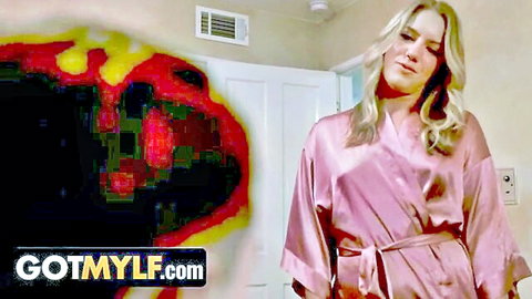 Seductive blonde MILF in pink silk robe ready to share bed with stepson