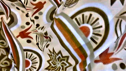Abstract colorful fabric pattern with red birds suns and geometric motifs
