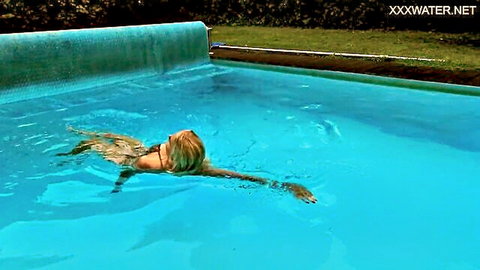 Blonde Emily Rossi swims sensually underwater in clear blue pool
