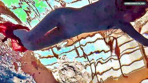 Moldovan beauty swims naked underwater in pool, showcasing toned legs and ass