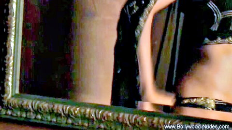 Sexy Indian goddess in black lingerie posing in mirror reflection