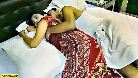 Indian couple in passionate honeymoon spooning sex with woman in red dress