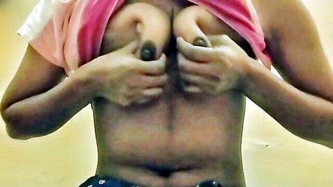 Desi Indian girl exposes and squeezes large brown tits lifting pink top