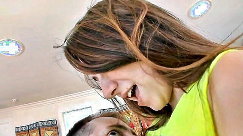 Alison Rey smiling close-up with partner in green top, nude tattoo tease