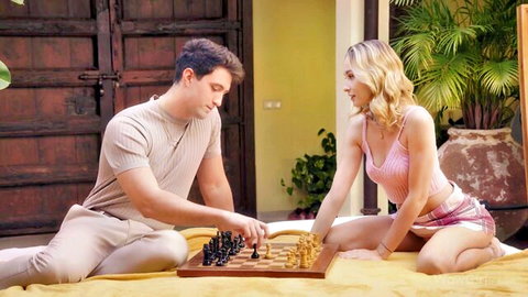 Kelly Collins in sexy pink top and shorts playing chess with partner