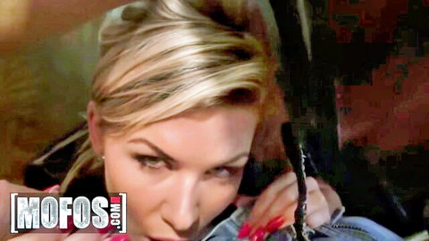 Seductive blonde MILF with long hair peeking through car window with sultry gaze