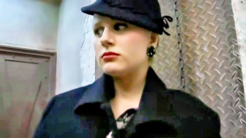 Vintage blonde woman in black beret hat and coat with red lips seductive gaze