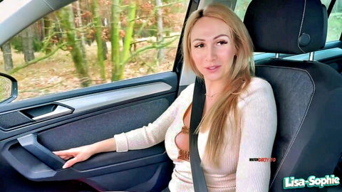 Blonde babe Lisa-Sophie teases massive tits cleavage in low-cut sweater car POV