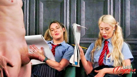 Two schoolgirls in uniforms read newspapers while one strokes huge cock in CFNM threesome