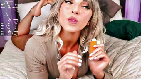 Blonde Eva Ra teases with orange toy, seductive pose on bed